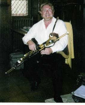painting of Paul Brennan playing the pipes
